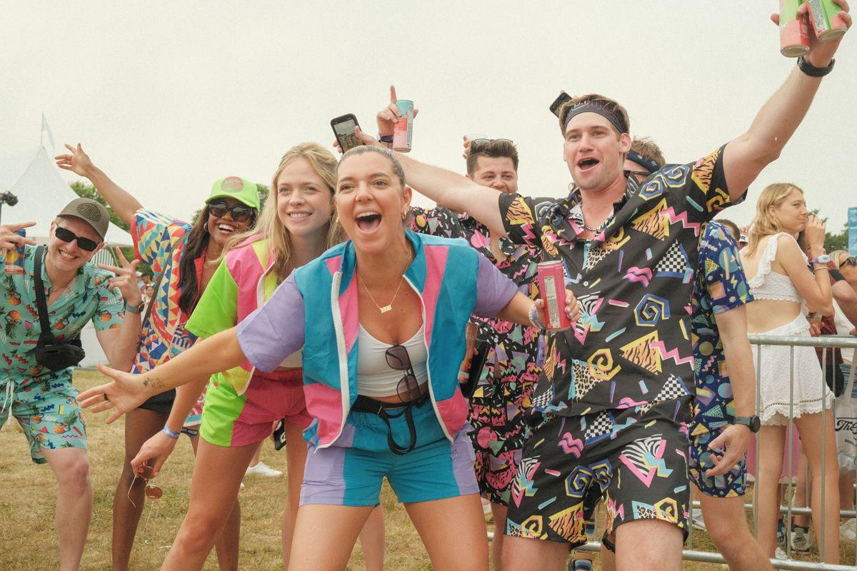 Party goers in retro clothes attending the Palm Tree Festival in the Hamptons