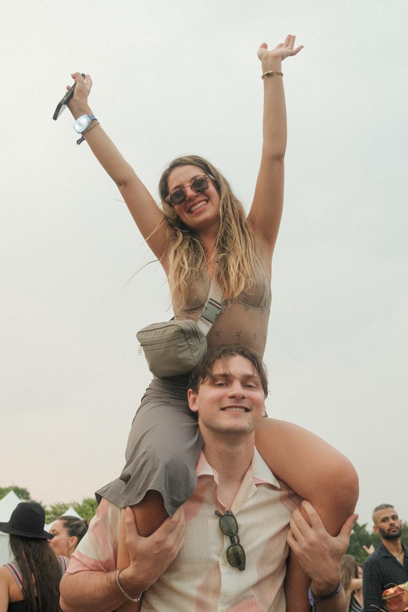 Girl sitting on the shoulder of another person at the Palm Tree Festival